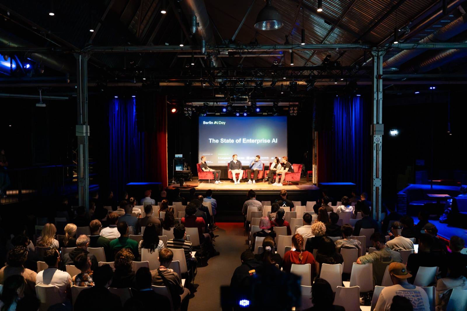 A panel on the Berlin AI Day main stage in front of a full room